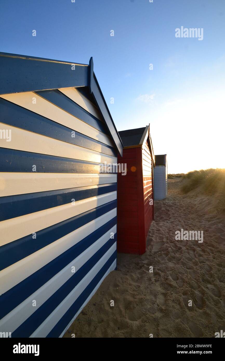 Southwold beach huts shining under the winter sun, Suffolk, United Kingdom Stock Photo