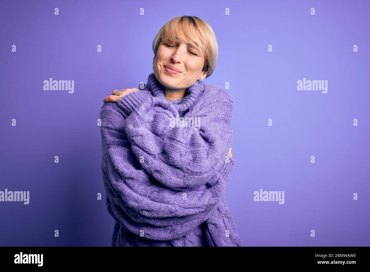 Young blonde woman with short hair wearing winter turtleneck sweater ...