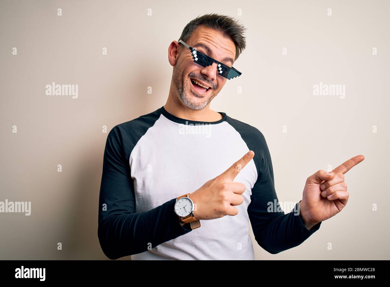 Young Handsome Man Wearing Funny Thug Life Sunglasses Meme Over White Background Smiling And Looking At The Camera Pointing With Two Hands And Fingers Stock Photo Alamy