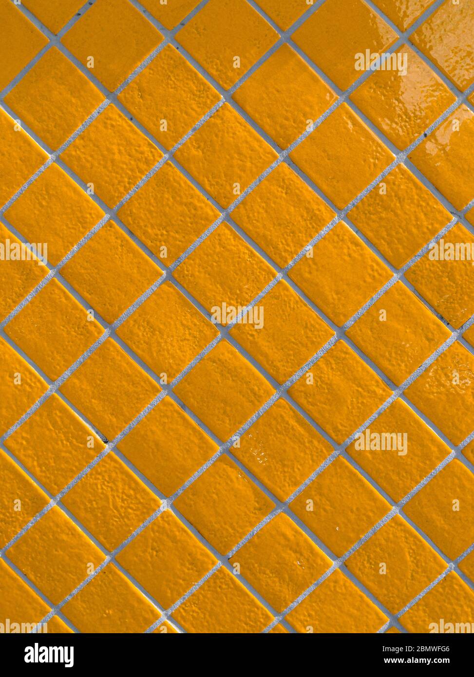Orange tiled wall pattern with textured glazed surface Stock Photo