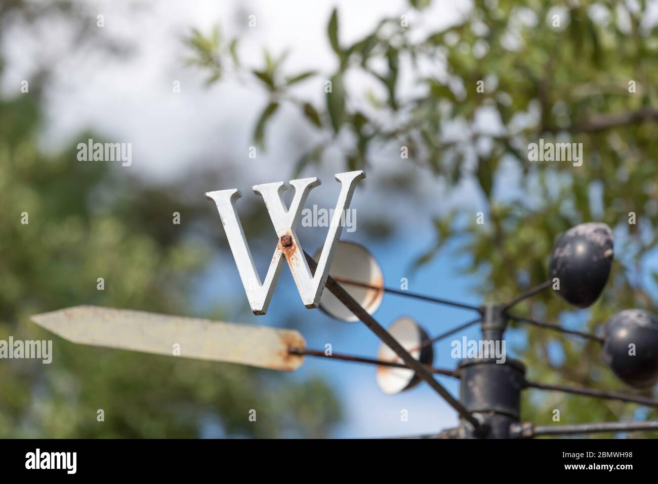A large white metal W symbol on a weather vane or wind vane in a Sydney, Australia garden Stock Photo