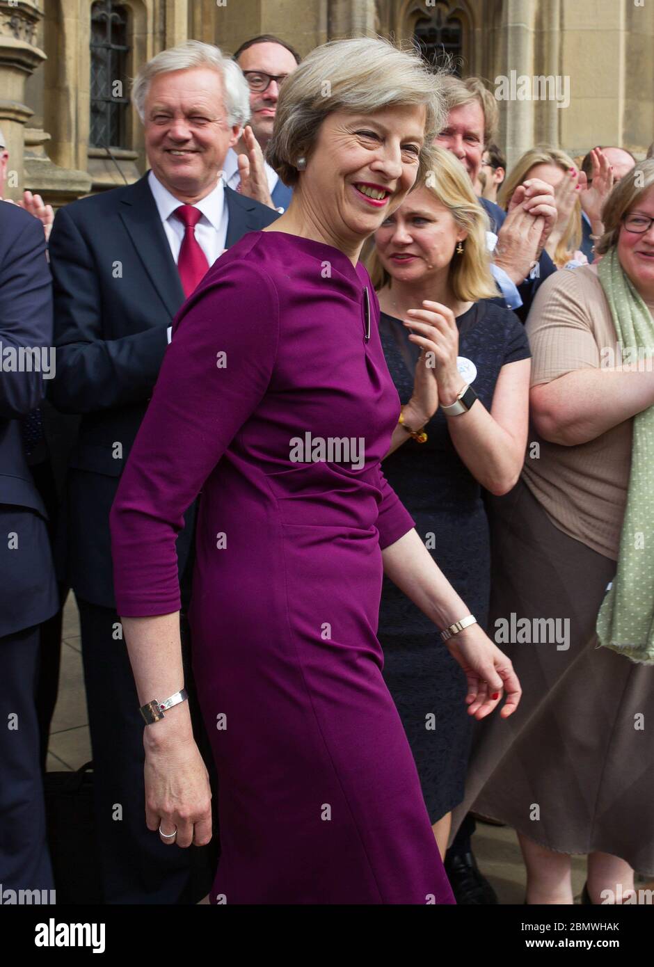 theresa may purple dress Theresa May appears outside St Stephen's Entrance at the palace of Westminster following her successful progression to the next stage of the conservat Stock Photo