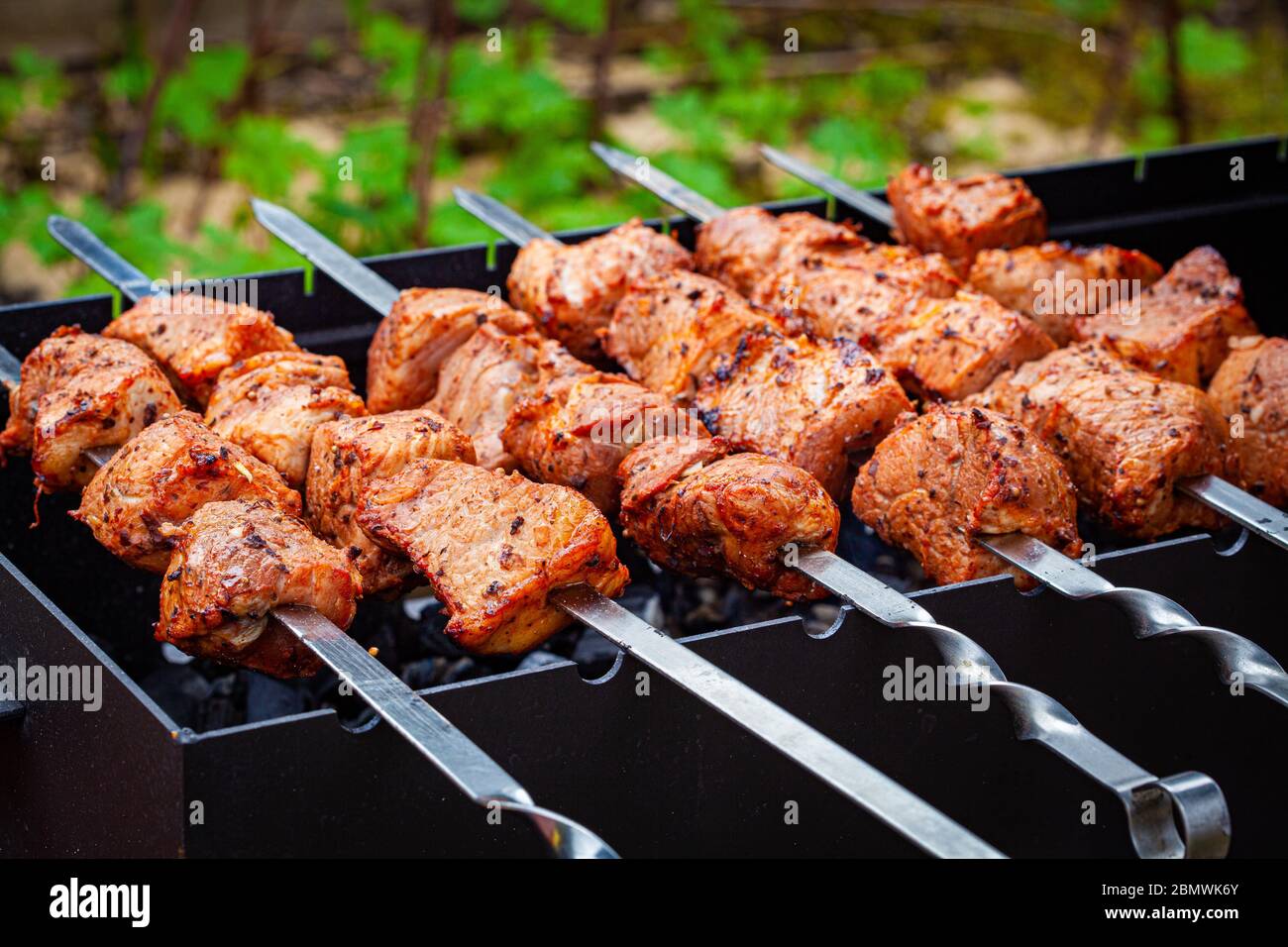 Homemade grilled pork kebab on an open grill. Outdoor food festival