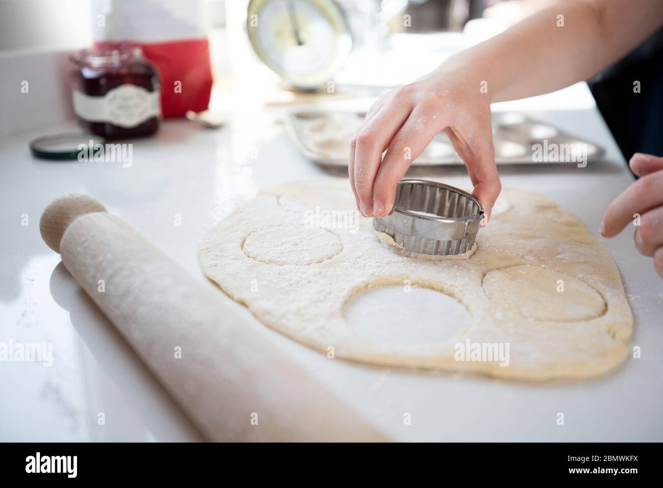 Close Up Of Girl Using Pastry Cutter Baking In Kitchen At Home Stock Photo