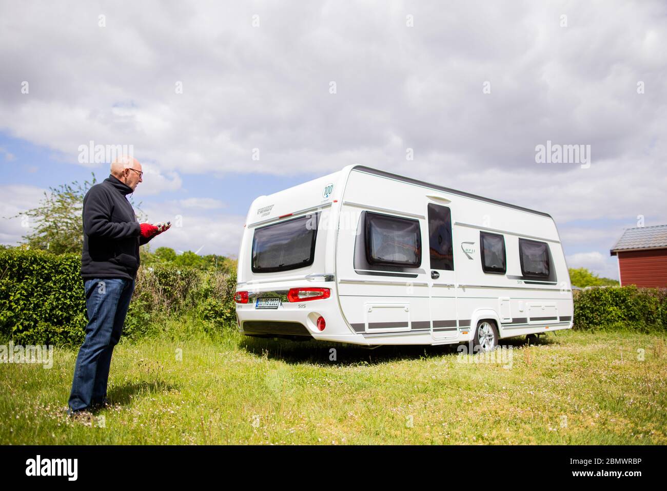 Kalkar, Germany. 11th May, 2020. Klaus-Peter Gelissen from Dortmund  manoeuvres his caravan by means of a remote control to the pitch on the  camping site at Lake Wisseler See, which he has