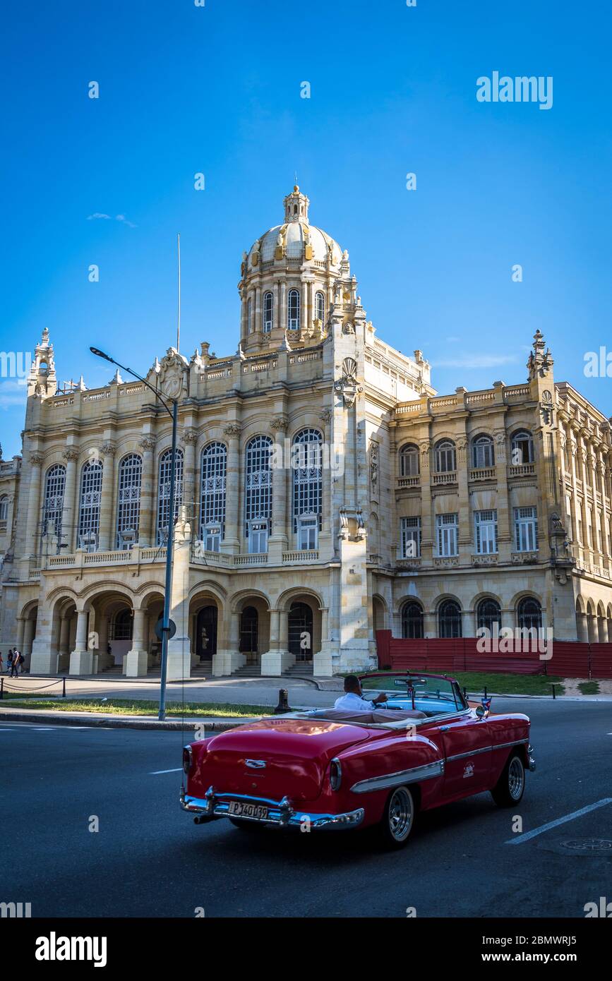 Classic car passing by Museum of the Revolution, former Presidential Palace of all Cuban presidents, Havana, Cuba Stock Photo