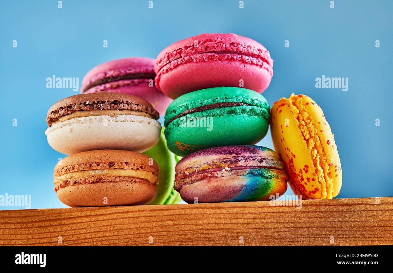 Multi-colored Macaron folded in a stack on a wooden background. Shooting from below Stock Photo