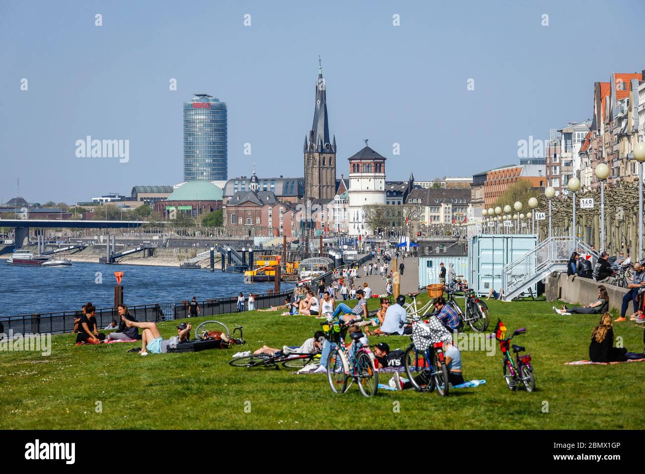 Duesseldorf, North Rhine-Westphalia, Germany - Rhine promenade in times of the corona pandemic with a ban on contact, in the back Basilica St. Lambert Stock Photo