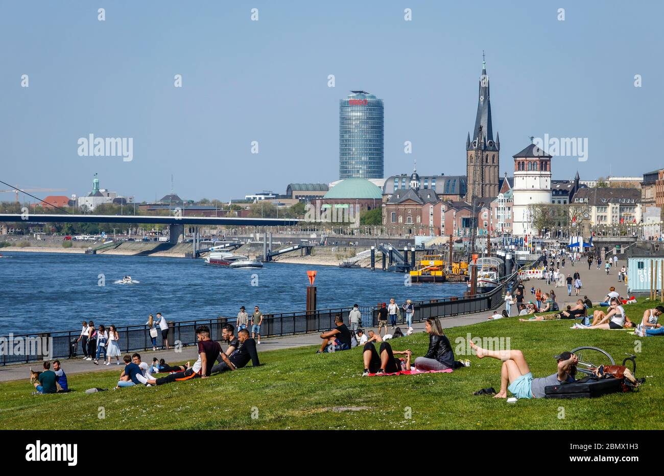 Duesseldorf, North Rhine-Westphalia, Germany - Rhine promenade in times of the corona pandemic with a ban on contact, in the back Basilica St. Lambert Stock Photo