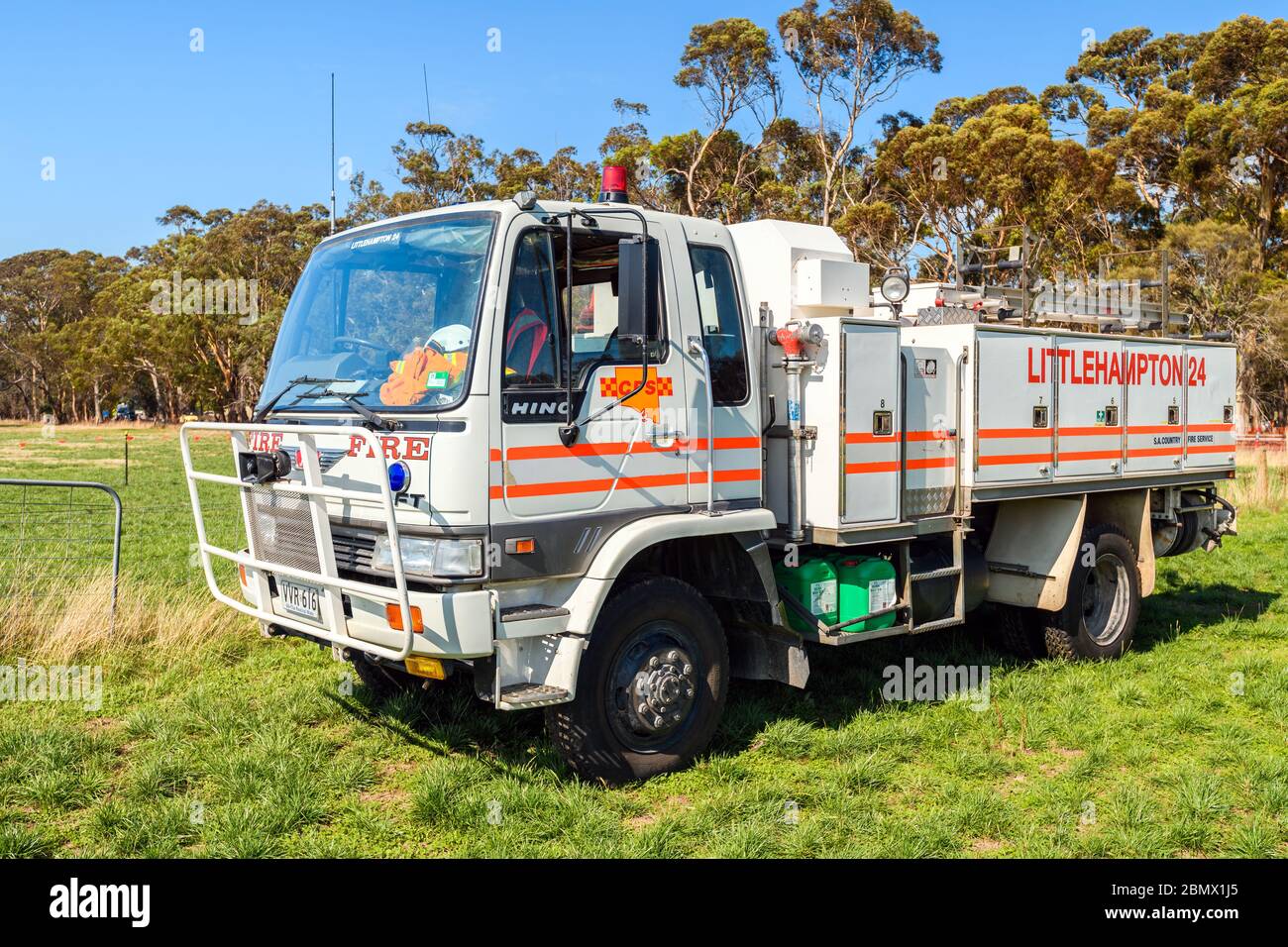 Adelaide Hills, South Australia - February 9, 2020: South Australian Country Fire Service truck parked on the green grass on a bright warm summer day Stock Photo