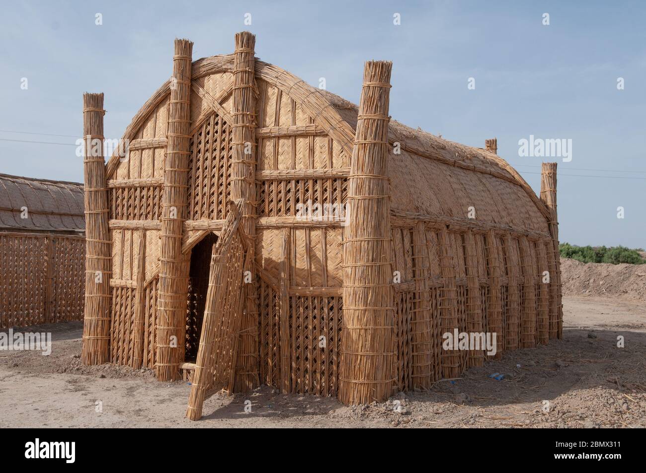 A Mudhif, traditional buildings made from dried reeds, in the marshes of Southern Iraq Stock Photo