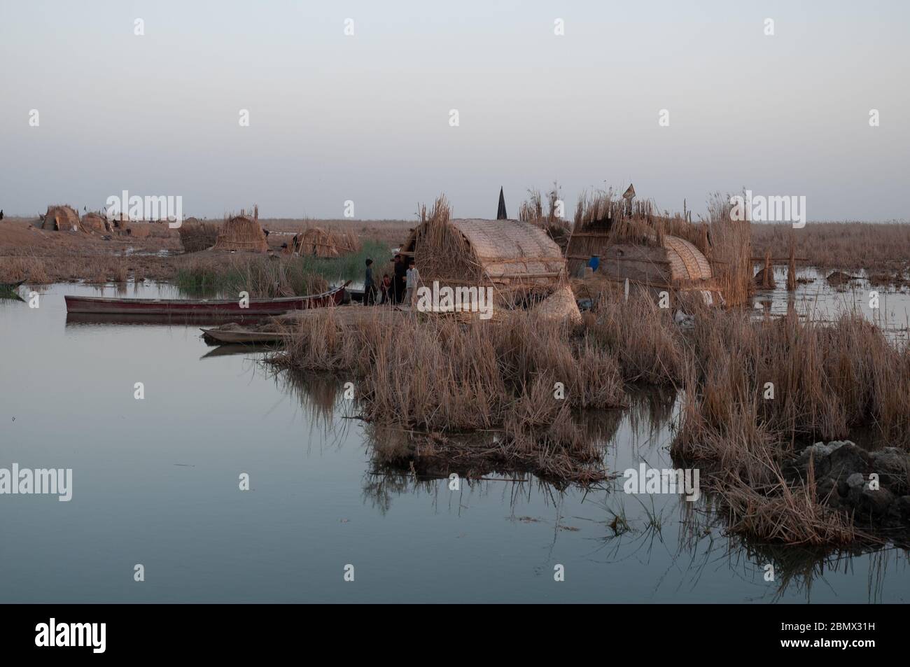A Marsh Arab traditional building constructed using dried reeds.  these buildings are sitting on a floating reed island, or Kibasha, central marshes of Southern Iraq Stock Photo
