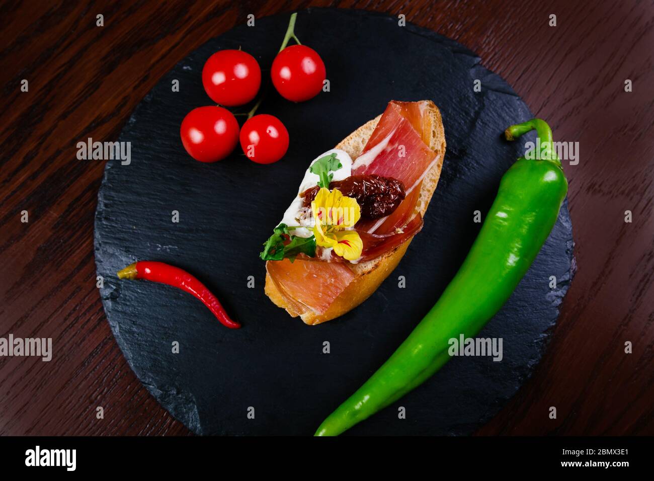 Spanish food tapas. Toasted bread with goat cheese and serrano ham ...