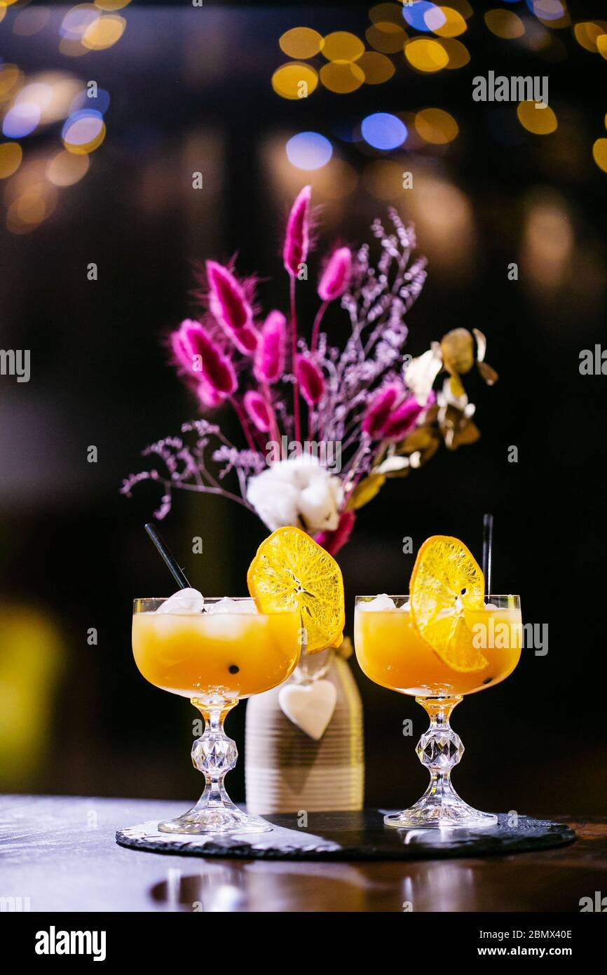 Attractive women are talking in cafeteria and drinking juice. They are