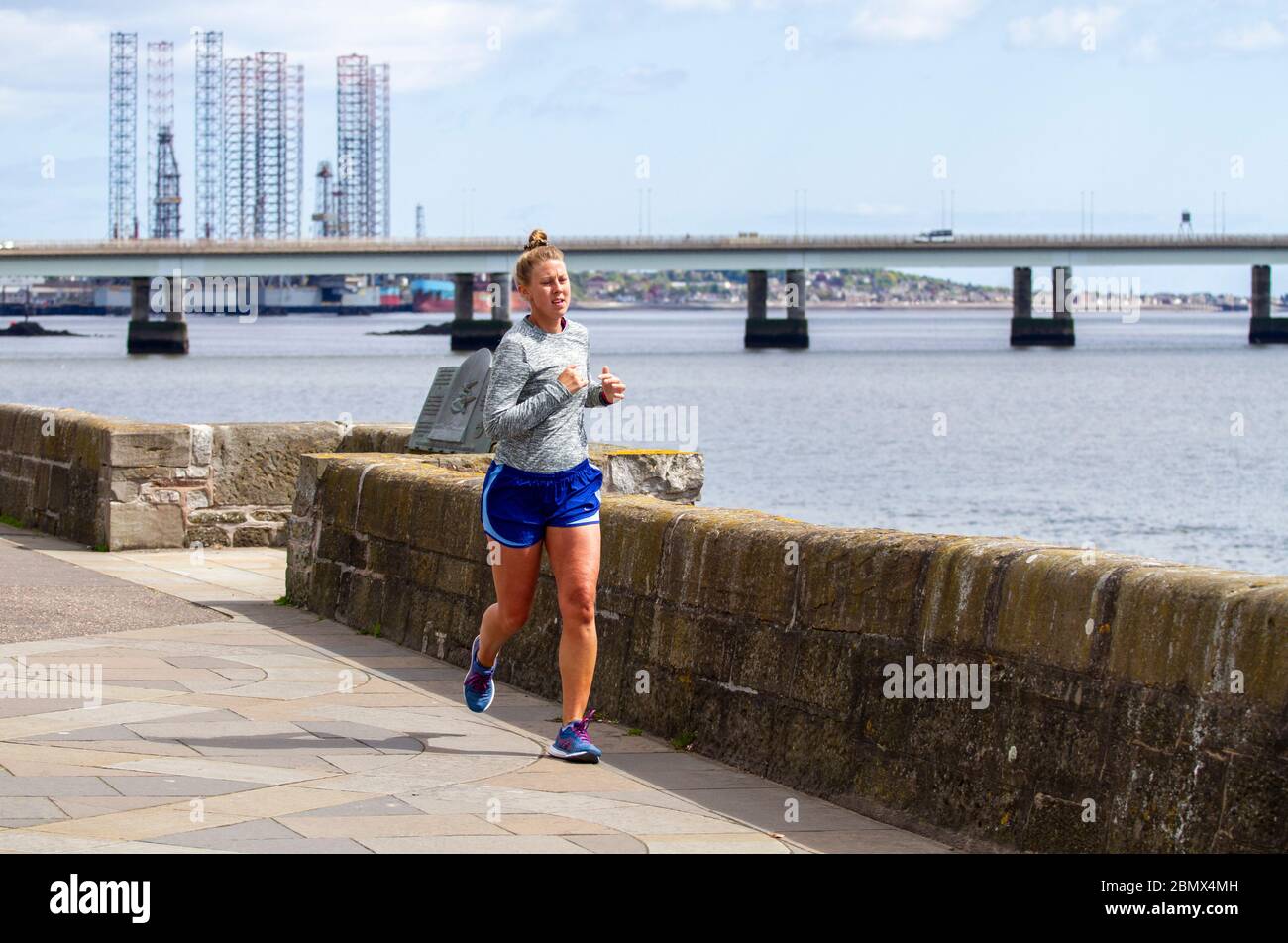 Dundee, Tayside, Scotland, UK. 11th May, 2020. UK Weather: A cooler day with sunshine in Dundee Scotland with maximum temperature 12°C. Local residents enjoying the weather while taking light outdoor exercises jogging along the riverside promenade during the Covid-19 lockdown restrictions. Credit: Dundee Photographics/Alamy Live News Stock Photo