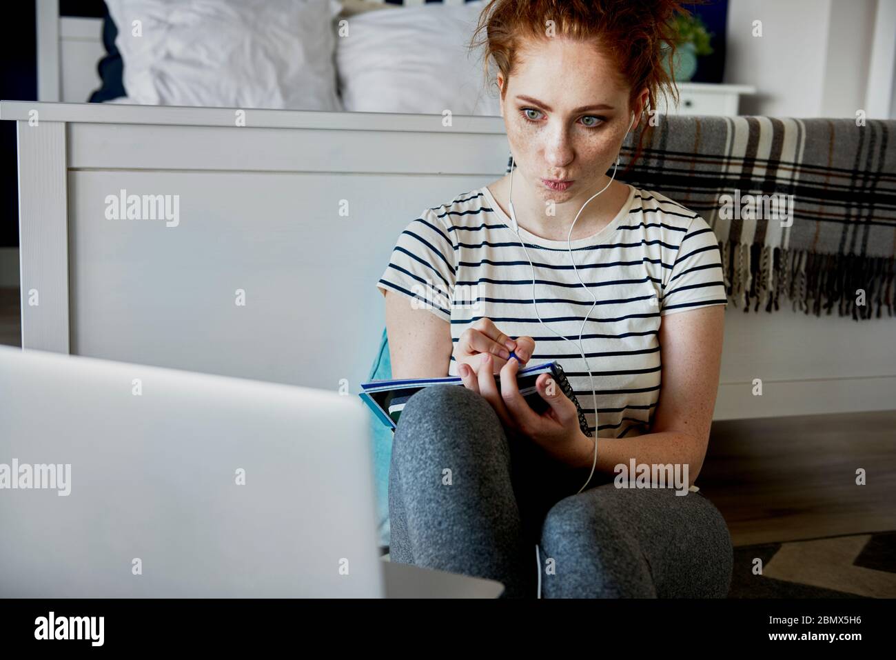 Woman having some problems with E-learning Stock Photo