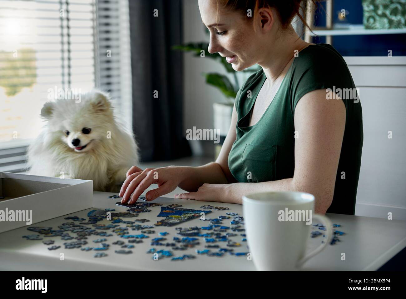 Young woman doing jigsaw puzzles Stock Photo