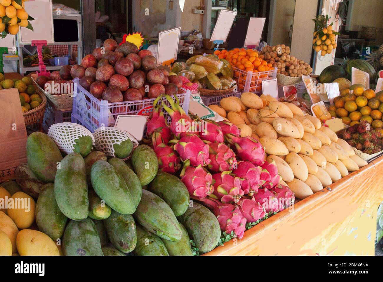 Fruit counter with mango, longan, dragon, mangosteen, lemons, tangerines in Thailand. Trade. Asia. Green diet. Stock Photo