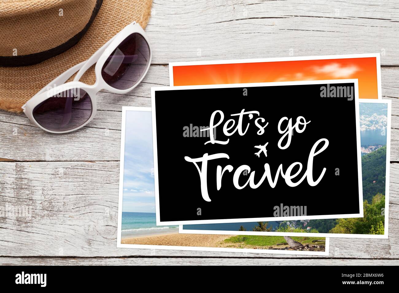 Travel concept with vacation photos,  sun hat and sunglasses on wooden table. Top view flat lay with copy space Stock Photo