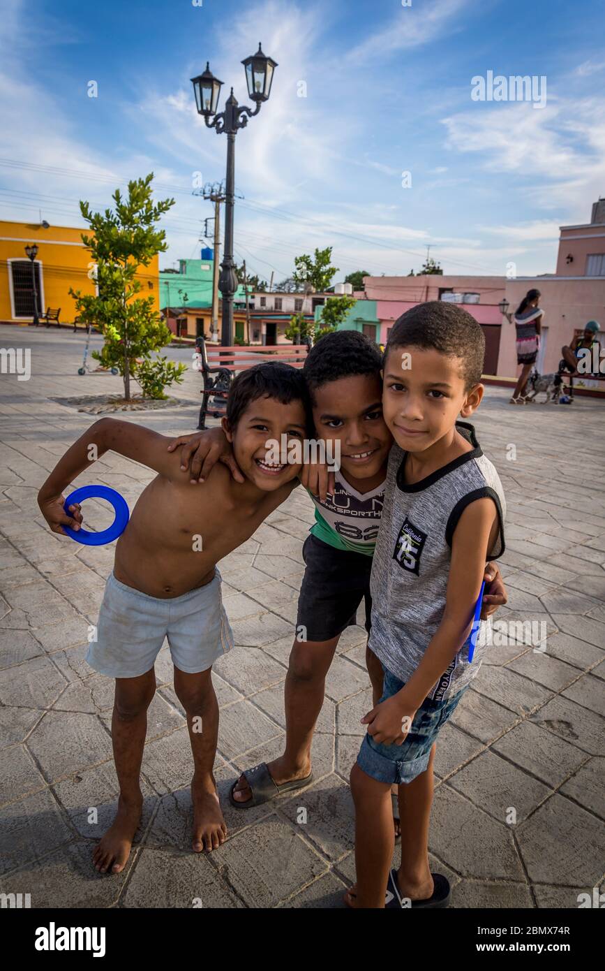 Three friends at the Santa Ana square, Trinidad, Cuba Stock Photo