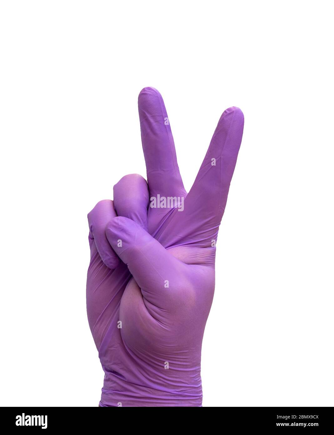 hand with medical glove doing the Victory gesture, symbolizing the win over COVID-19. Stock Photo