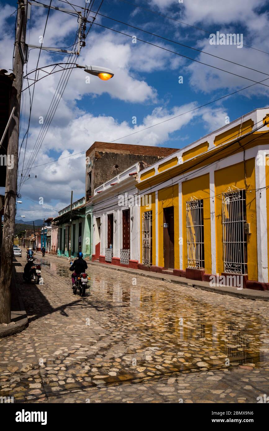 Typical cobblestoned street with colourful houses in the colonial era centre of the town, Trinidad, Cuba Stock Photo