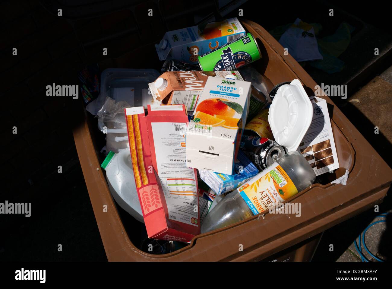 A full recycling bin due to extra waste whilst in lockdown during the coronavirus pandemic. Stock Photo