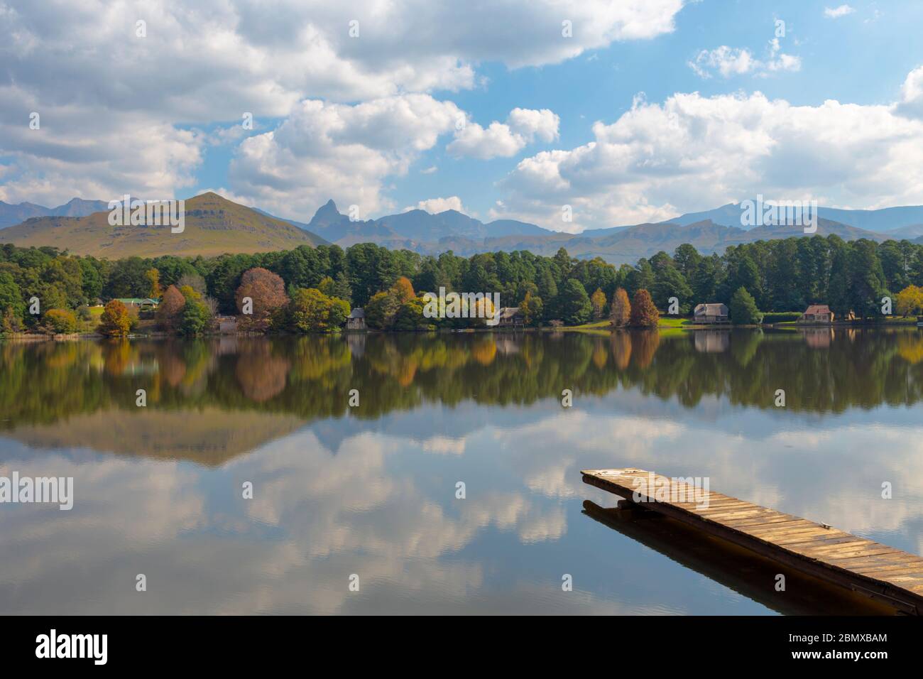 Reflection of clouds and autumn colored trees on the lake Stock Photo ...