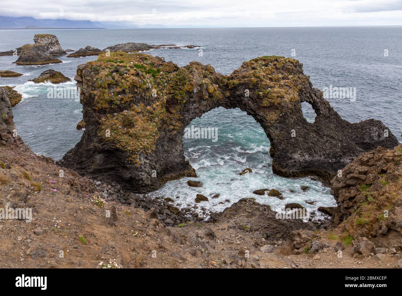 Gatklettur ("Hellnar Arch"), a stunning rock arch and basalt coastline at Arnarstapi, Snæfellsnes peninsula, Iceland. Stock Photo