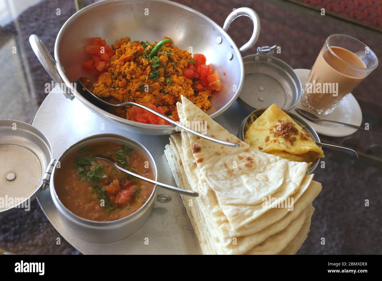 Bahrain breakfast of eggs, tomatoes, chilies, beans, tea and flat bread