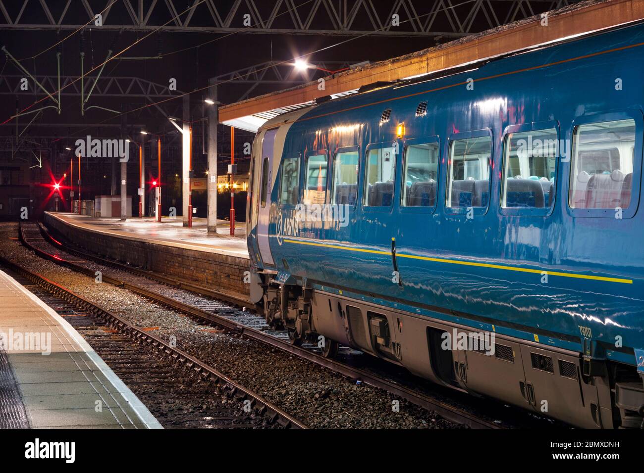 Arriva Trains Wales Alstom class 175 Coradia train 175007 waiting at Crewe railway station with a late night train with a red danger signal Stock Photo