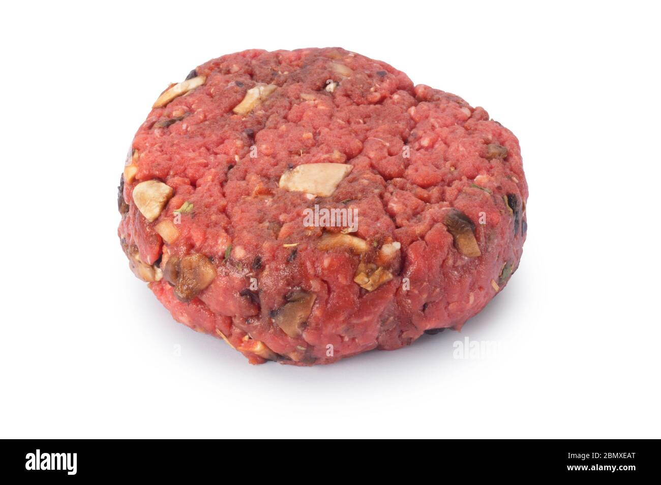 Studio shot of uncooked beef burger cut out against a white background - John Gollop Stock Photo