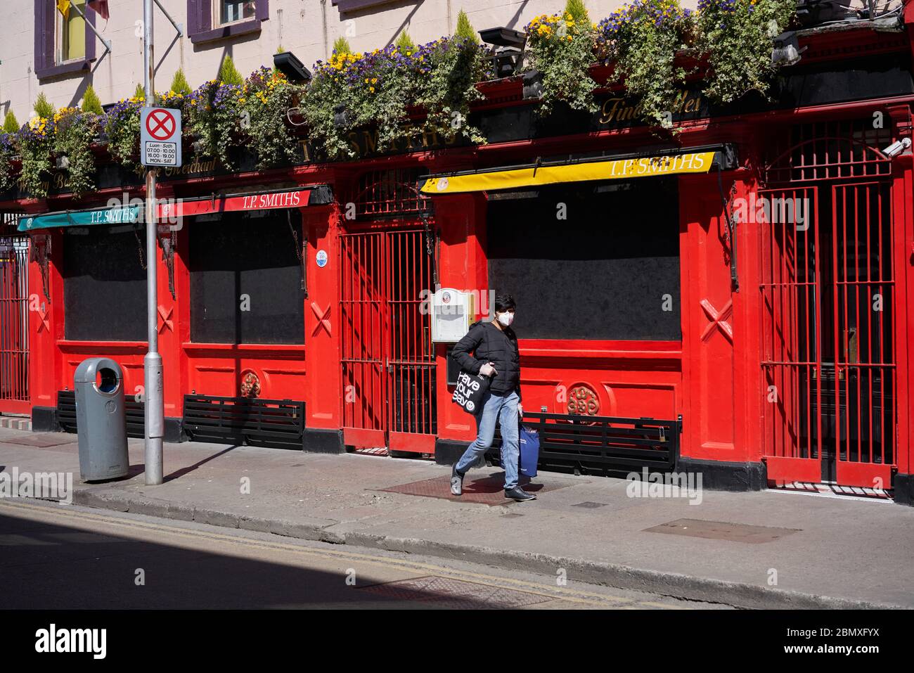 A Man Wearing A Face Mask During The Coronavirus Pandemic Walks Along A Street In Dublin City Ireland Stock Photo Alamy