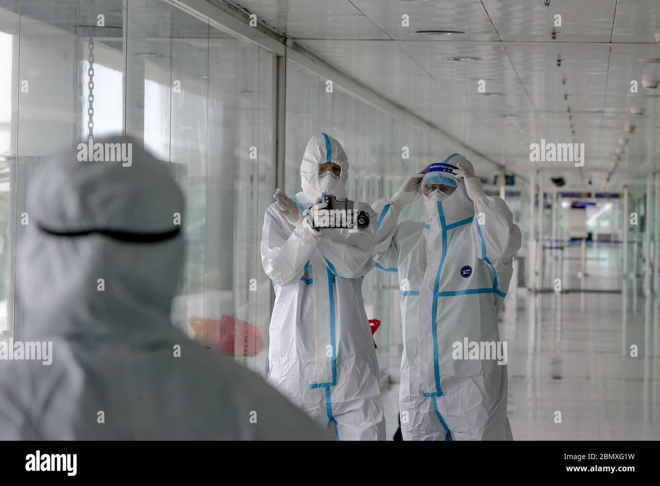 Manila. 11th May, 2020. Health workers wearing protective suits wait for the arrival of Filipinos returning from London at the Manila Ninoy Aquino International Airport in the Philippines, May 11, 2020. All foreigners and Filipinos arriving in the Philippines need to undergo testing for the COVID-19 and quarantine to stem the spread of the virus, Presidential spokesperson Harry Roque said on Monday. Credit: Rouelle Umali/Xinhua/Alamy Live News Stock Photo