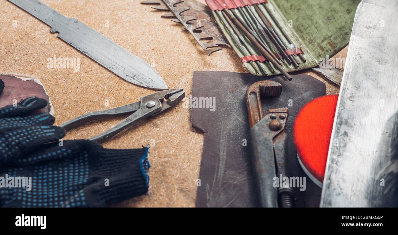 Working tools on wooden rustic background. top view. Knife making concept Stock Photo