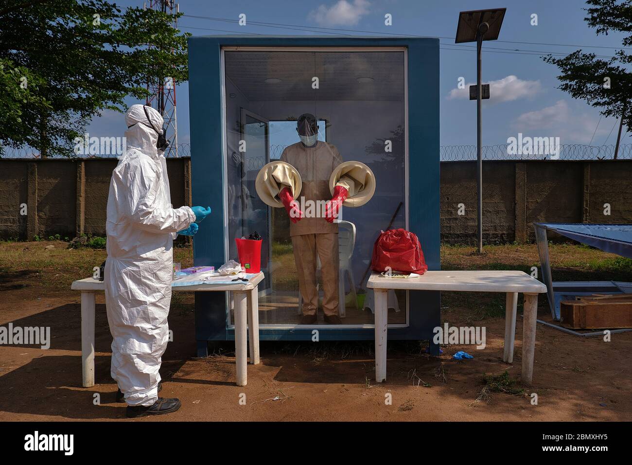A medical doctor stands inside a Covid-19 Test Sample Collection Testing Booth in Ogun State, Nigeria. Stock Photo