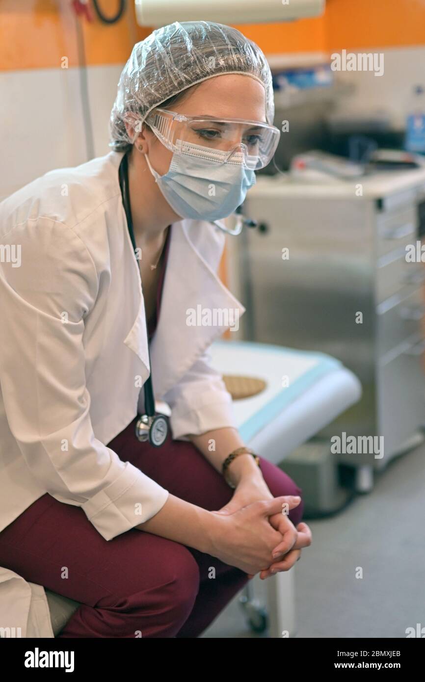 Tired doctor nurse in goggles hi-res stock photography and images - Alamy