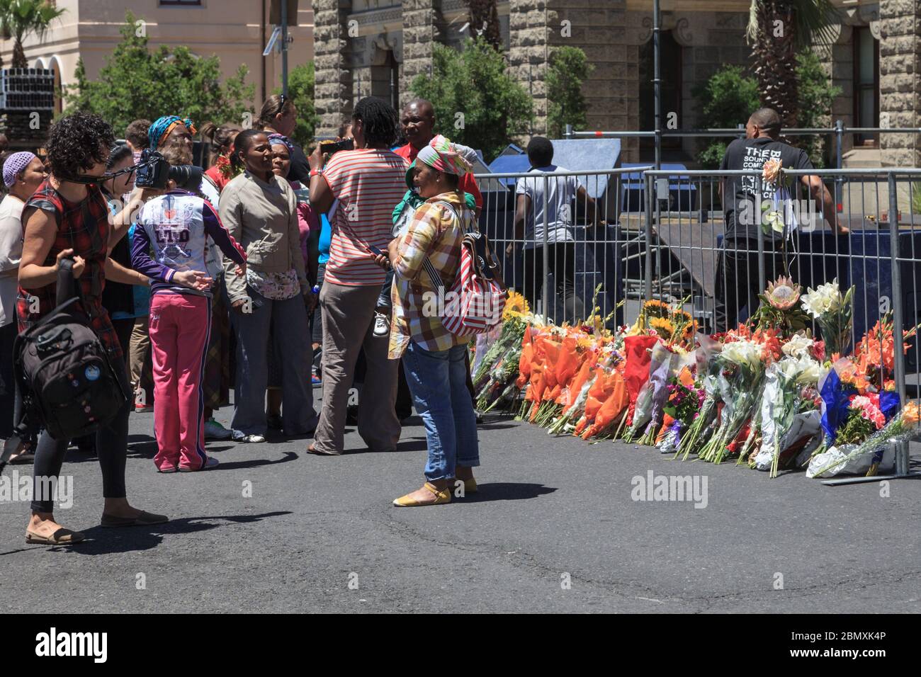 People gather and lay flowers outside Cape Town City Hall on Dec 6, 2013, the  day after the death of the former president, South Africa Stock Photo