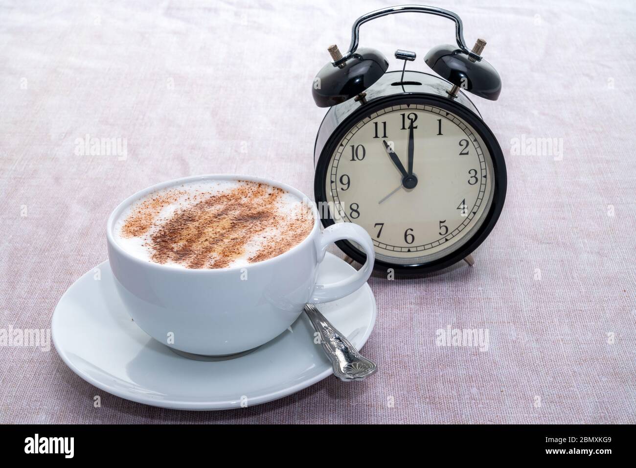 Coffee time alarm clock with a hot cappuccino Stock Photo Alamy
