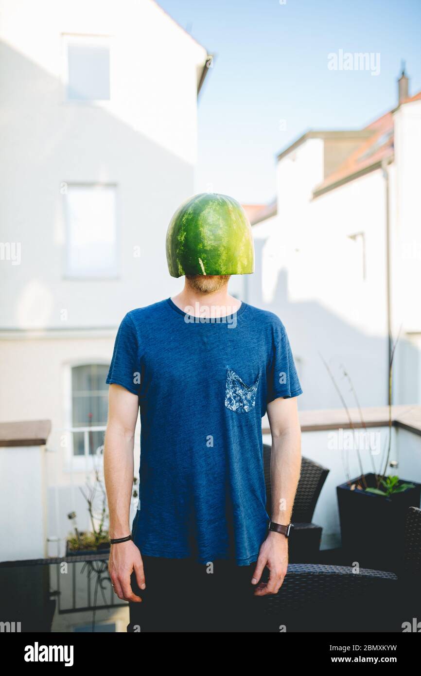 Man wearing a melon as a helmet Stock Photo Alamy