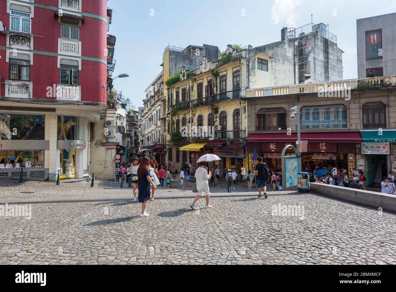 A morning view of a busy street with people shopping on city center in Macau, China. Stock Photo