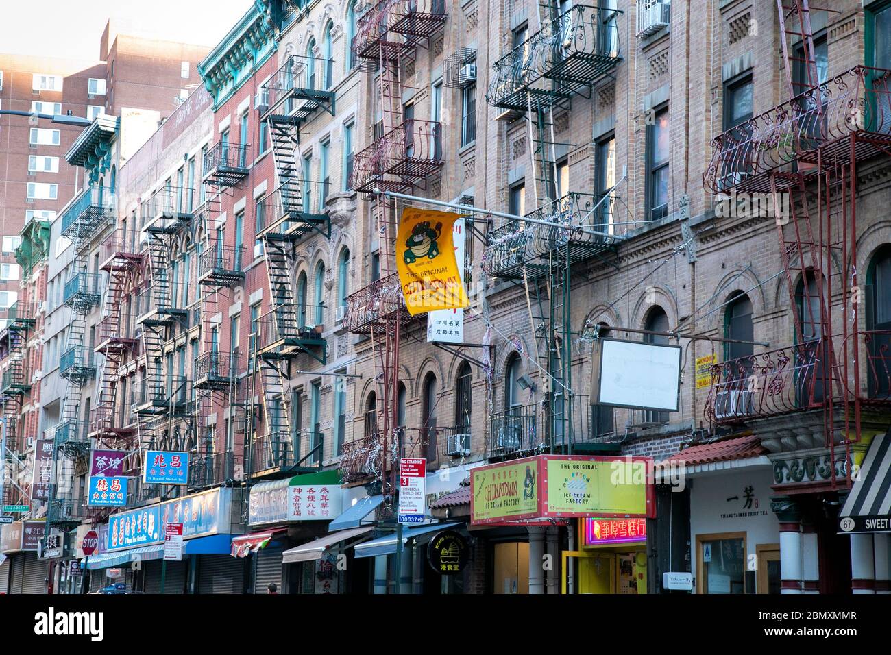 Old apartment buildings with fire escapes outside in Chinatown, NYC. Stock Photo