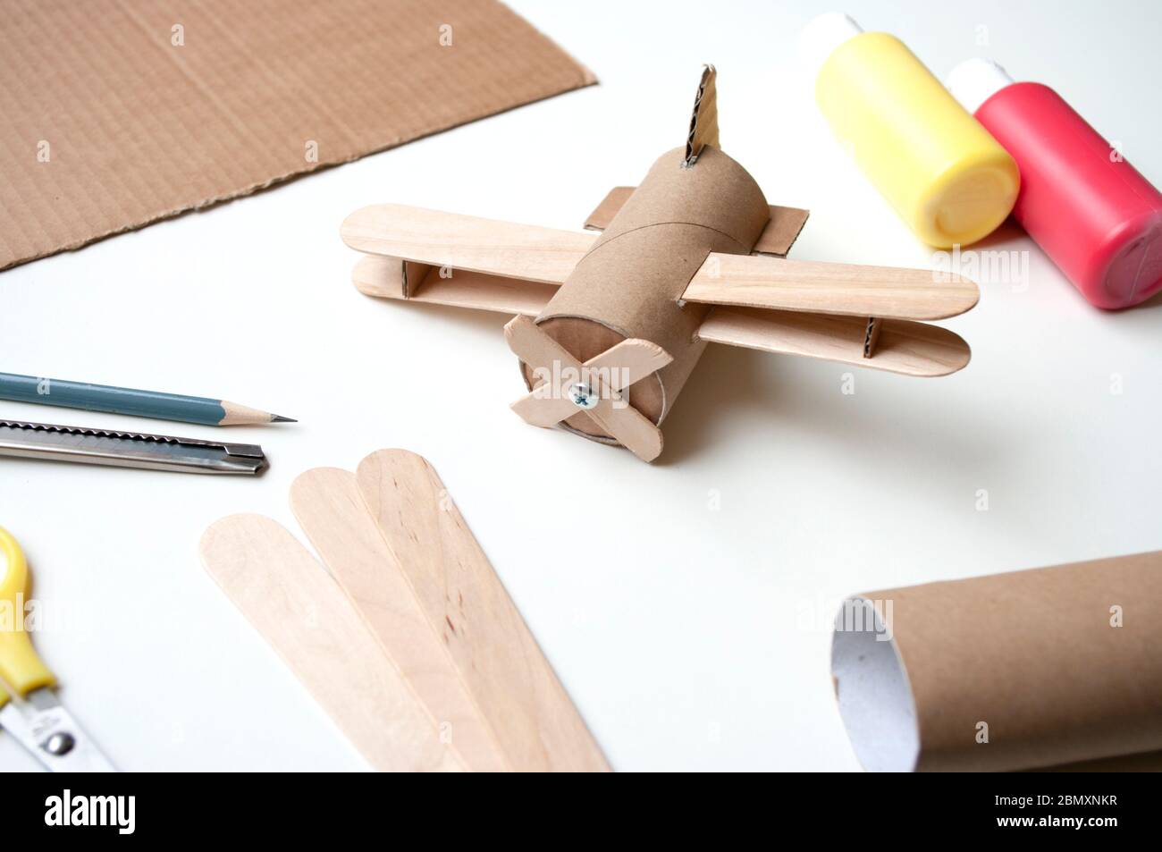 How to make aircraft toy from toilet paper roll and popsicle sticks. Zero  waste DIY. Decoration for child room, skill share. Handmade ideas during  Stock Photo - Alamy