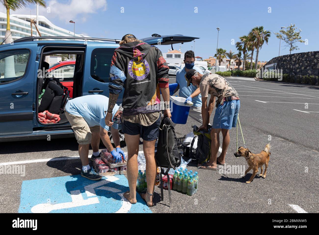 La Caleta, Costa Adeje, Tenerife, Canary Islands. 11 May 2020. Food bank charity El Arca de Noe, Noahs Ark, run by British residents provide food, water and soft drinks to a group of homeless people living rough along the Costa Adeje coastline. They rely on donations from local businesses and distribute basic foodstuffs to over a hundred people three times a week. Stock Photo