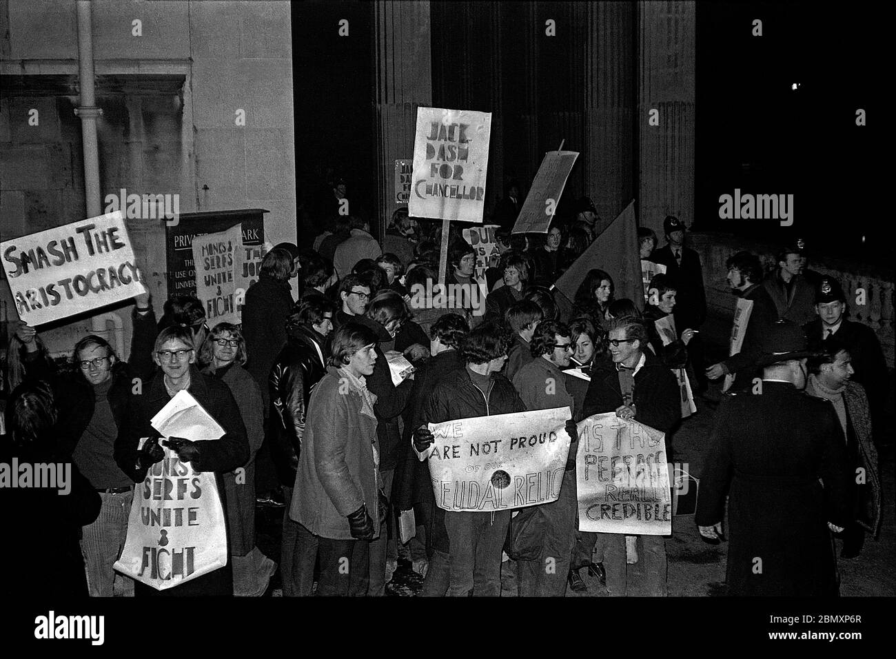 Student demonstrators protesting against the Duke of Beaufort being Bristol University’s Chancellor picket outside the Victoria Rooms as he arrives for Op Soc’s Gala Performance of Offenbachs “La Grande-Duchesse de Gerolstein” on 14 February 1969.  Some placards called for the Duke to be replaced by Jack Dash, a communist trade union leader prominent in London Dock Strikes. Stock Photo