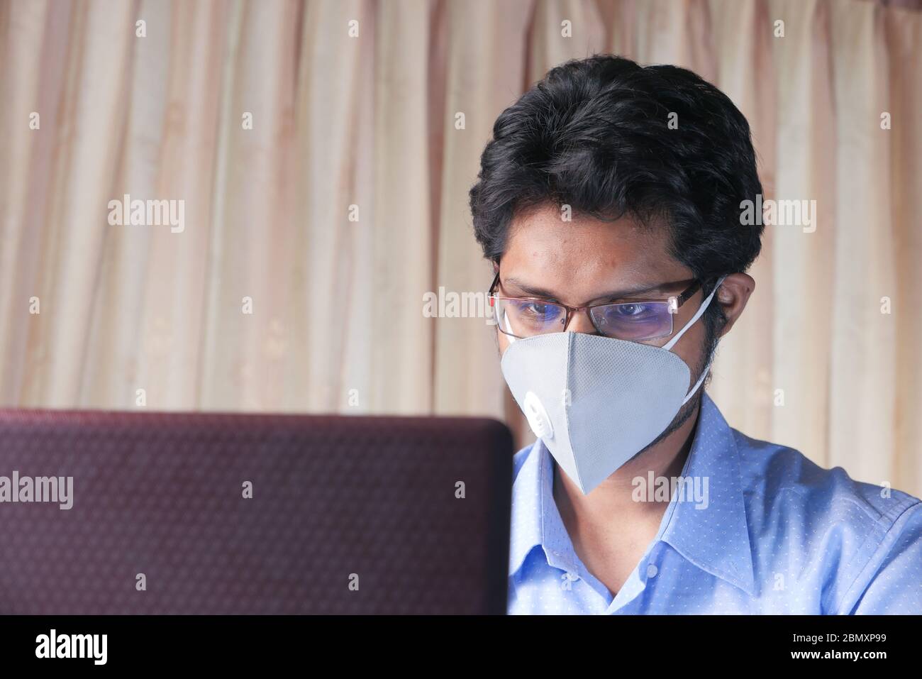 Man working from home. Using laptop. Stock Photo