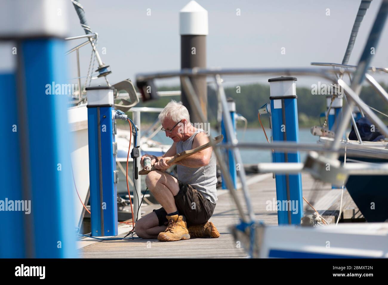 yacht owner working at UK boatyard Stock Photo