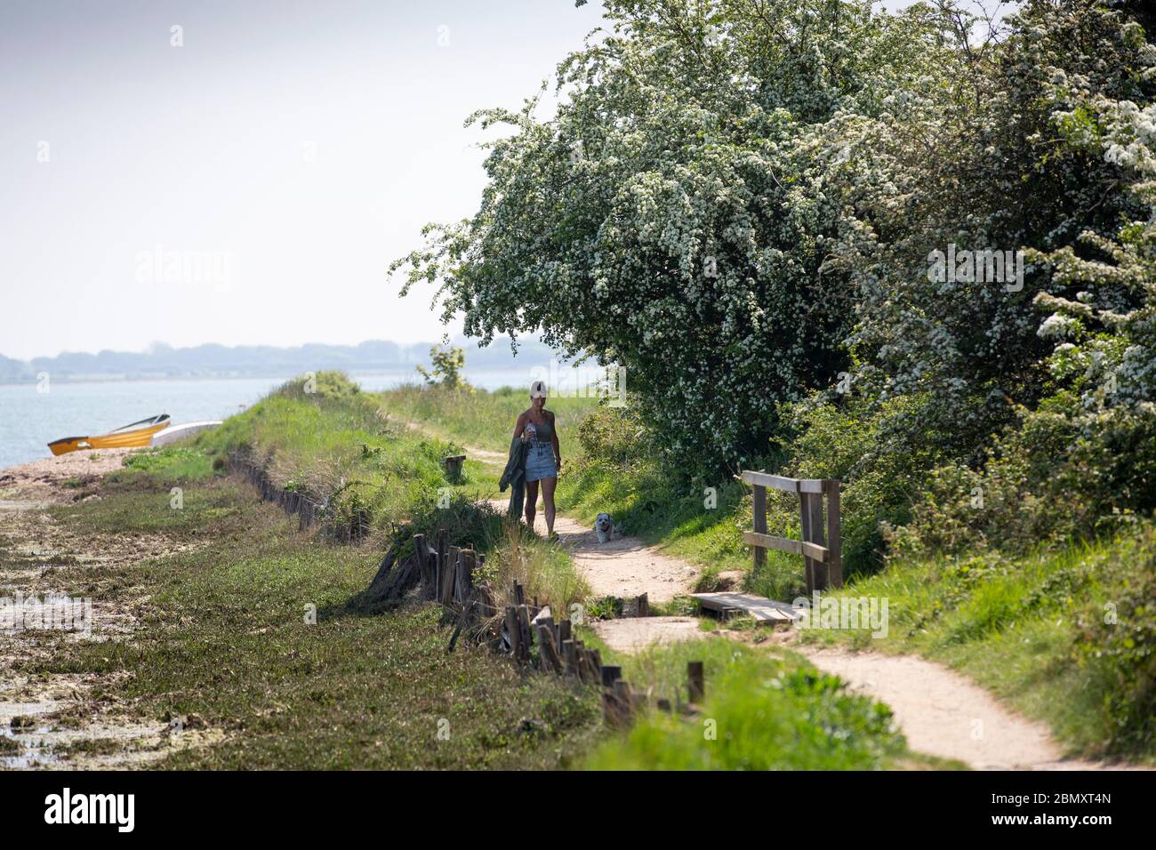 Young woman walking alone along coastal path during 2020 Covid-19 outbreak Stock Photo