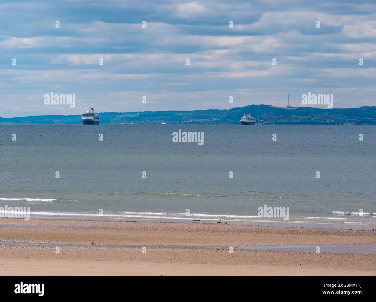 Aberlady nature reserve, East Lothian, Scotland, United Kingdom. 11th May, 2020. UK Weather: Quiet at the reserve during the Covid-19 lockdown with a deserted beach and Fred Olsen mothballed out of service cruise ships anchored in the Firth of Forth Stock Photo