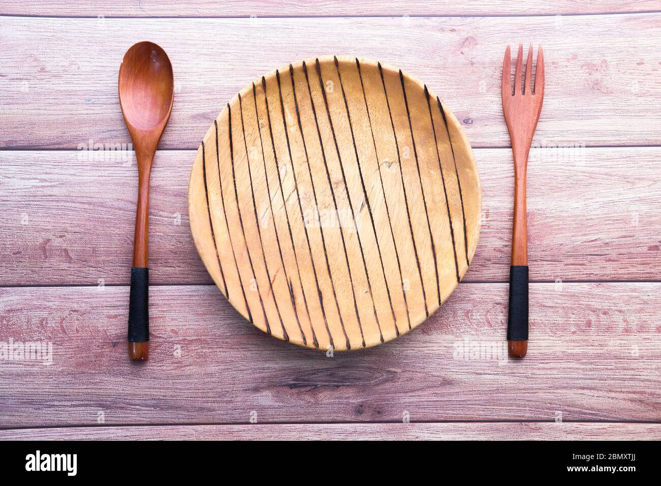 Clean empty plate with knife and fork on table  Stock Photo